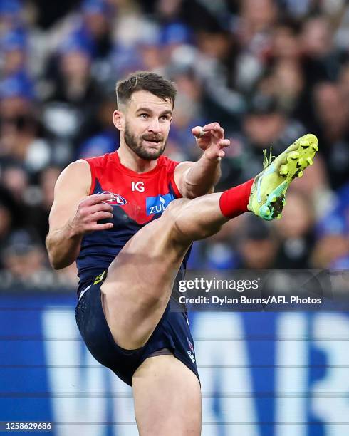 Joel Smith of the Demons kicks the ball during the 2023 AFL Round 13 match between the Melbourne Demons and the Collingwood Magpies at the Melbourne...