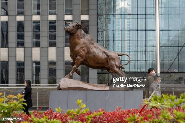 Pedestrians pass the new building of the Shanghai Stock Exchange in Shanghai, China, March 29, 2023.