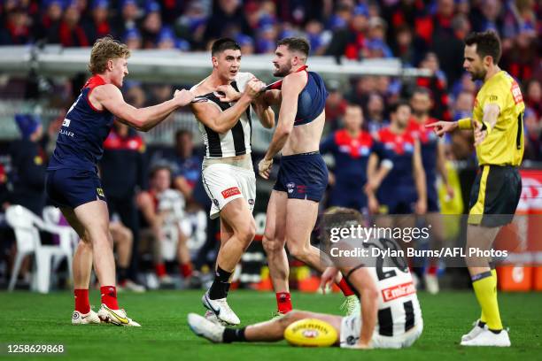 Brayden Maynard of the Magpies remonstrates with Joel Smith of the Demons as Nathan Murphy of the Magpies lays injured during the 2023 AFL Round 13...