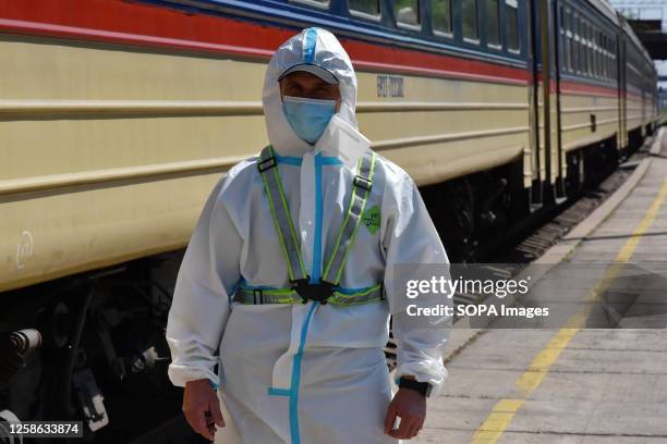 Doctor wearing a radiation protection suit stands near an evacuation train during a training on radiation exposure. Ukraine's nuclear energy agency...