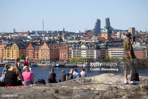 Visitors at a viewpoint overlooking the city skyline in Stockholm, Sweden, on Sunday, June 11, 2023. Swedish households are becoming more optimistic...