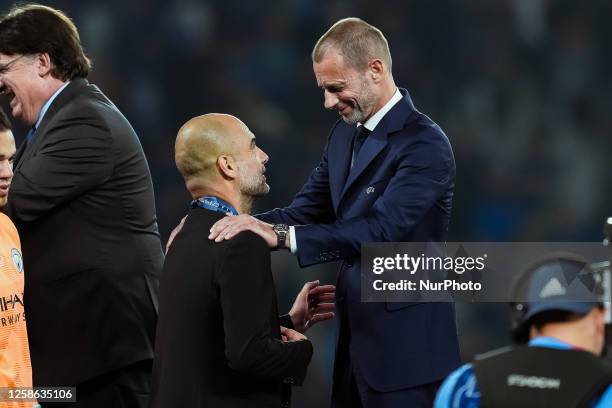 Aleksander Ceferin presents Pep Guardiola manager of Manchester City with his winners' medal at the end of the UEFA Champions League final match...