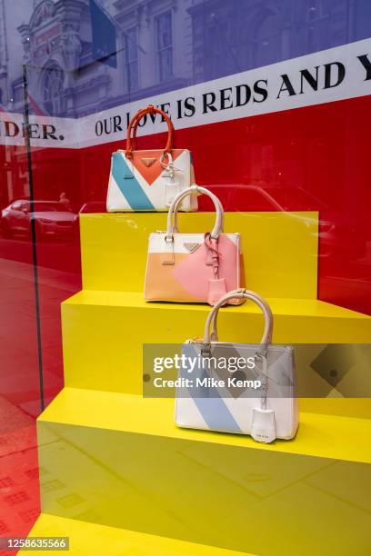 Prada handbag in a shop window of their store on Bond Street on 22nd May 2023 in London, United Kingdom. Bond Street is one of the principal streets...