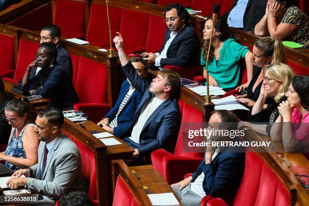 French leftist La France Insoumise party Member of Parliament Louis Boyard raises his hand to contest during a debate to examinate the no-confidence...