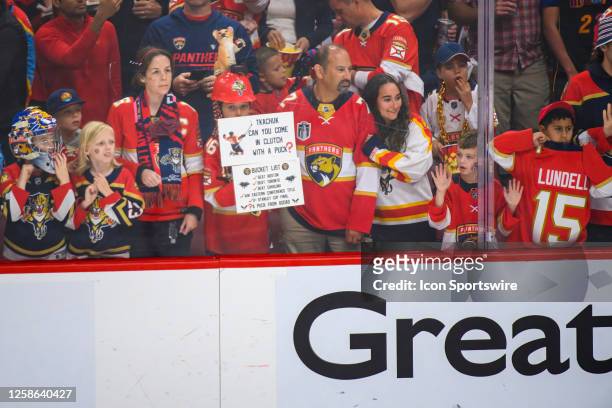 Panthers fans hold up signs as they watch the players warmup before the start of Game Four of the NHL Stanley Cup Final between the Vegas Golden...