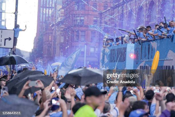 Manchester City players during the bus parade as it passes through the streets of Manchester to celebrate winning the Champions League, Premier...