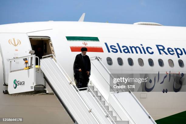 Iranian President Ebrahim Raisi disembarks after landing at Simon Bolivar International Airport in Maquetia, La Guaira State, Venezuela, on June 12,...