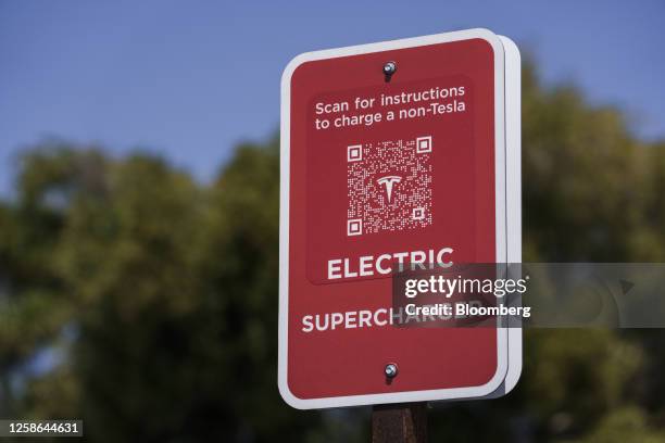 Sign informs customers how to charge their non-Tesla vehicles at a Tesla Supercharger location in Scotts Valley, California, US, on Thursday, June 1,...