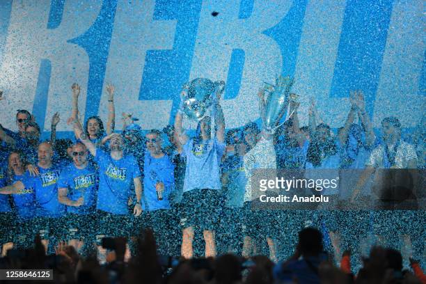 Manchester City players celebrate victory with fans as they make a stop during their bus parade to celebrate on stage at the St. Peter's Square,...