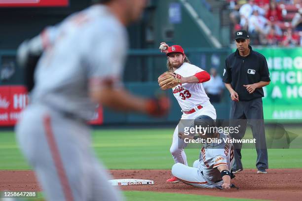 Brendan Donovan of the St. Louis Cardinals attempts to turn a double play over Michael Conforto of the San Francisco Giants in the second inning at...