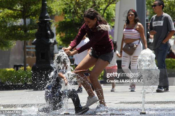 Child plays in a water fountain during one of the hottest days of the third heat wave in Guadalajara, Jalisco state, Mexico, on June 12, 2023.