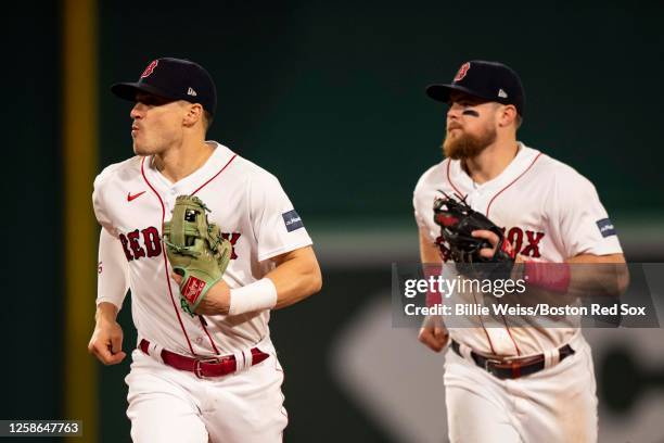 Enrique Hernandez and Christian Arroyo of the Boston Red Sox react after turning a double play during the seventh inning against the Colorado Rockies...