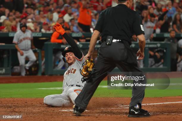 Patrick Bailey of the San Francisco Giants scores the game-winning run in the eighth inning against the St. Louis Cardinals at Busch Stadium on June...