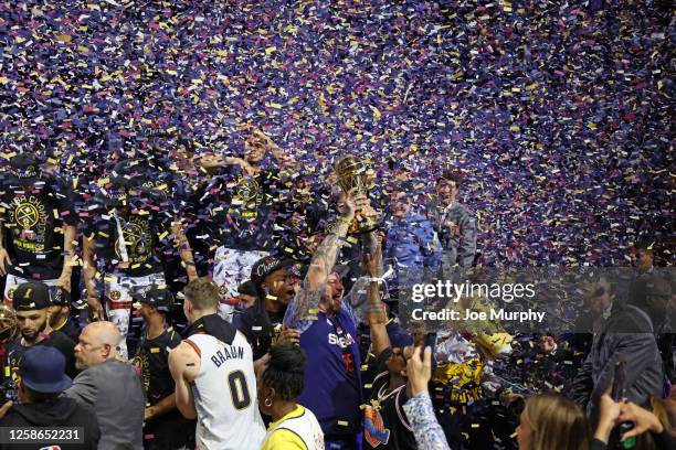 Strahinja Jokic, brother of Nikola Jokic of the Denver Nuggets, celebrates with the Bill Russell Finals MVP Trophy after Game Five of the 2023 NBA...