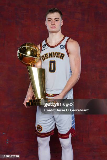 Christian Braun of the Denver Nuggets poses for a portrait with the Larry O'Brien Trophy after winning Game Five of the 2023 NBA Finals on June 12,...