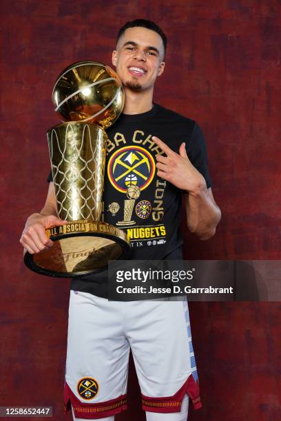 Michael Porter Jr. #1 of the Denver Nuggets poses for a portrait with the Larry O'Brien Trophy after winning Game Five of the 2023 NBA Finals on June...