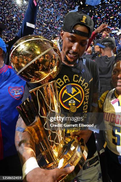 Kentavious Caldwell-Pope of the Denver Nuggets celebrates with the Larry O'Brien after winning Game Five of the 2023 NBA Finals against the Miami...