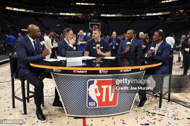 Nikola Jokic of the Denver Nuggets talks with NBA TV analysts Brendan Haywood, Matt Winer, Dennis Scott, and Isiah Thomas after Game Five of the 2023...