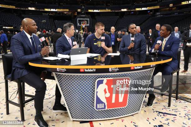 Nikola Jokic of the Denver Nuggets talks with NBA TV analysts Brendan Haywood, Matt Winer, Dennis Scott, and Isiah Thomas after Game Five of the 2023...