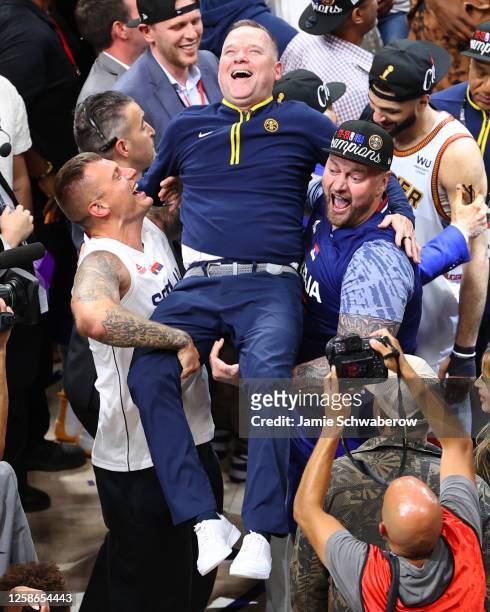 Nikola Jokic of the Denver Nuggets' brothers Strahinja and Nemanja Jokic, celebrate with Head Coach Michael Malone of the Denver Nuggets after...