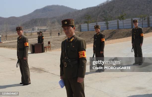 North Korean soldiers wait to check journalists as they arrive at the Tongchang-ri space center in North Phyongan Province on the west coast on April...