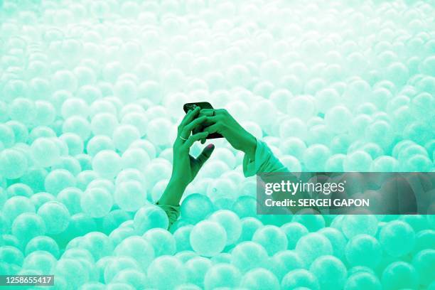 Woman enjoys the atmosphere as she visits the Alchemist restaurant in Copenhagen, Denmark, on May 25, 2023. With off-the-wall dishes like butterfly...