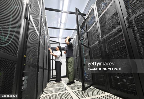 Employees check a server room of Samsung Networks' Telco Data Center at the headquarters of Samsung Electronics in Suwon on June 13, 2023.