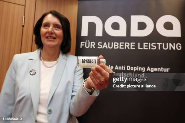 Andrea Gotzmann, CEO of the National Anti-Doping Agency Germany , holds a soap bottle with the inscription "Stay clean" during the presentation of...