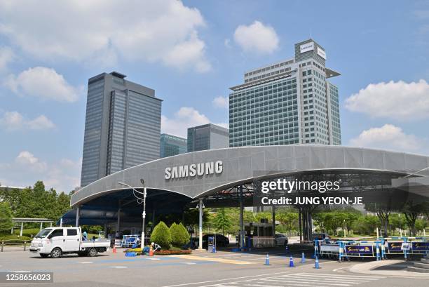 The logo of Samsung Electronics is seen on a gate at the company's headquarters in Suwon on June 13, 2023.