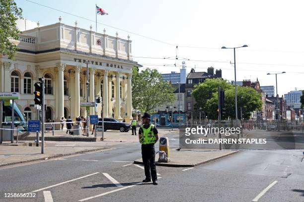 Police officer stands by a cordon outside the Theatre Royal on Upper Parliament Street in Nottingham, central England, during a 'major incident' in...