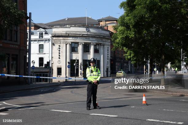 Police officer stands by a cordon on Upper Parliament Street in Nottingham, central England, during a 'major incident' in which three people have...