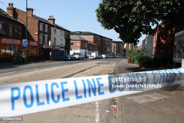 Police tape marks a cordon on Ilkeston Road in Nottingham, central England, during a 'major incident' in which three people have been found dead. UK...