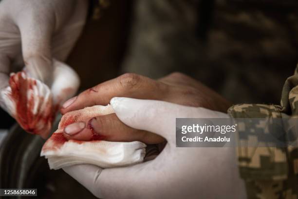 An injured soldier is treated at a medical stabilization center near the frontline in Zaporizhzhia, Ukraine on June 12, 2023. The soldier was not...