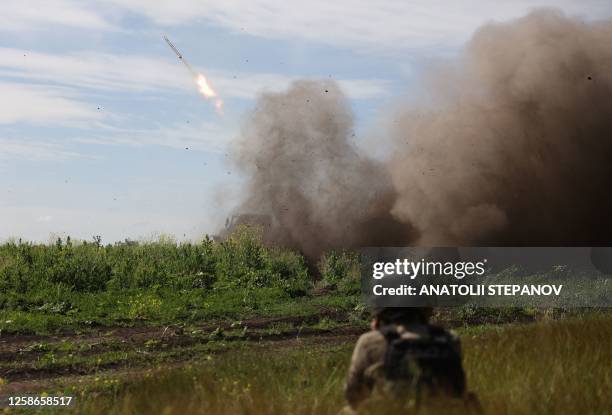 Ukrainian servicemen of the 10th Mountain Assault Brigade "Edelweiss" fire a rocket from a BM-21 'Grad' multiple rocket launcher towards Russian...