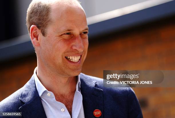 Britain's Prince William, Prince of Wales react as he attends the opening of Centrepoint's Reuben House in London on June 13, 2023. Rueben House is...