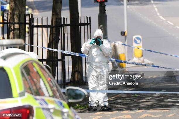 Police forensic officer takes pictures at the scene in Nottingham, United Kingdom on June 13, 2023. Three people have been found dead and a man has...