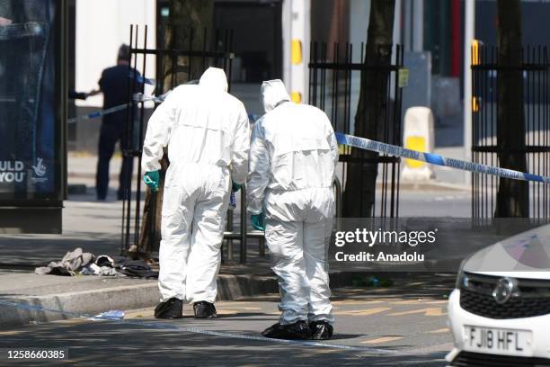 Police forensics inspect the scene in Nottingham, United Kingdom on June 13, 2023. Three people have been found dead and a man has been arrested...