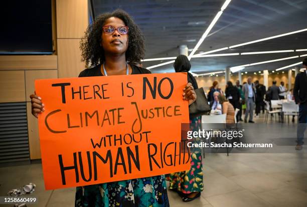 Protesters demonstrating over climate justice, loss and damage, fossil fuels, human rights, exploitation by rich countries of poor countries and...