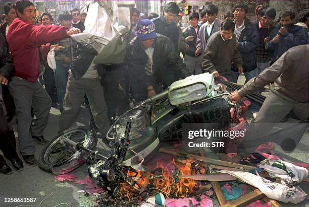 Demonstrating teachers throw a police motorcycle into a bonfire 19 May during a rally in downtown La Paz to press the government for higher wages....