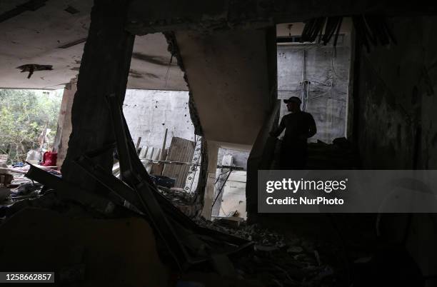 Palestinian man walks in his destroyed house in Gaza City which was hit during the latest round of fight between Gaza militants and the Israeli army,...