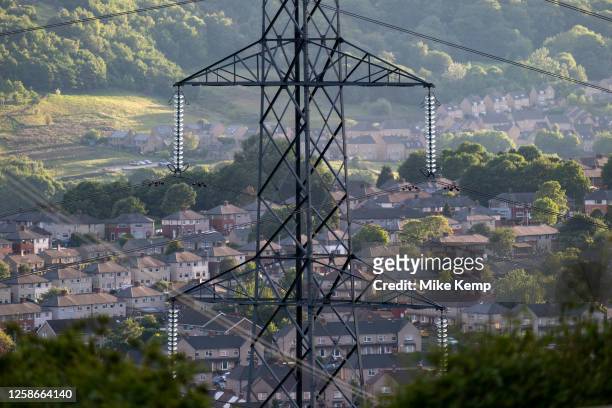 Electricity pylons view over homes just outside the town centre on 7th June 2023 in Halifax, United Kingdom. Halifax is a town in the borough of...