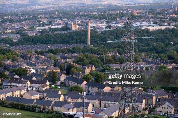 Old mill workers cottages within the terraced streets just outside the town centre with new build homes in the foreground on 4th June 2023 in...