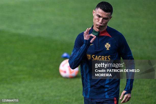 Portugal's forward Cristiano Ronaldo gestures as he attends a training session at Cidade do Futebol in Oeiras, outskirts of Lisbon on June 13, 2023...