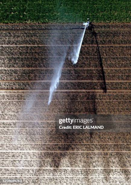 Aerial drone picture shows the watering of a field in Hellecine, Tuesday 13 June 2023. BELGA PHOTO ERIC LALMAND