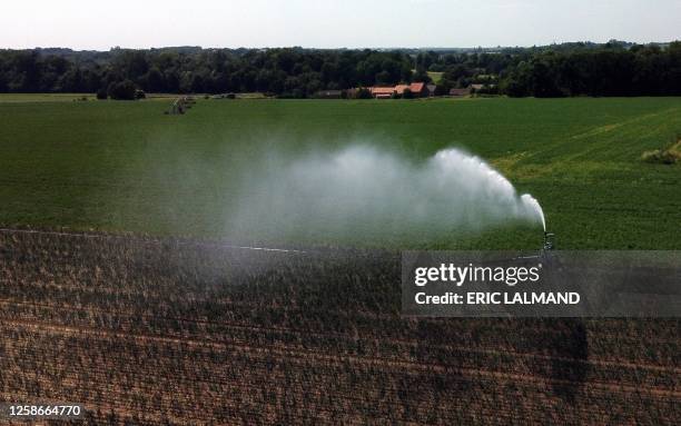 Aerial drone picture shows the watering of a field in Hellecine, Tuesday 13 June 2023. BELGA PHOTO ERIC LALMAND