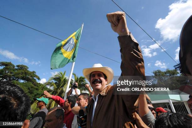 Ousted Honduran President, Manuel Zelaya , waves to supporters and reporters after arriving at the Brazilian Embassy in Tegucigalpa on September 21,...