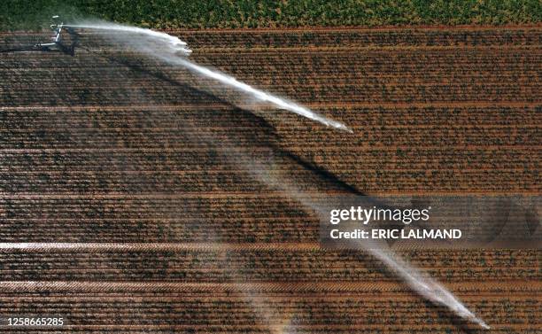 Aerial drone picture shows the watering of a field in Hellecine, Tuesday 13 June 2023. BELGA PHOTO ERIC LALMAND