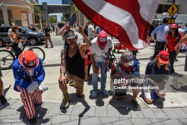 Supporters of former U.S. President Donald Trump pray outside the Wilkie D. Ferguson Jr. United States Federal Courthouse where former President...
