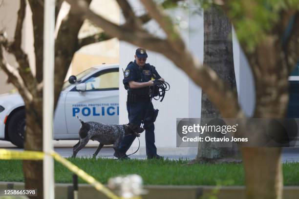 Federal police K-9 unit patrols before the arrival of former President Donald Trump at the Wilkie D. Ferguson Jr. United States Federal Courthouse...