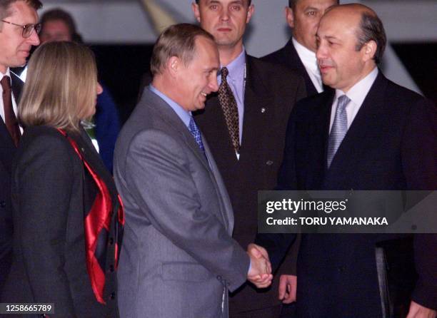 Accompanied by his wife Ludmila , Russian Prime Minister Vladimir Putin is welcomed by Russian Foreign Minister Igor Ivanov upon his arrival at...